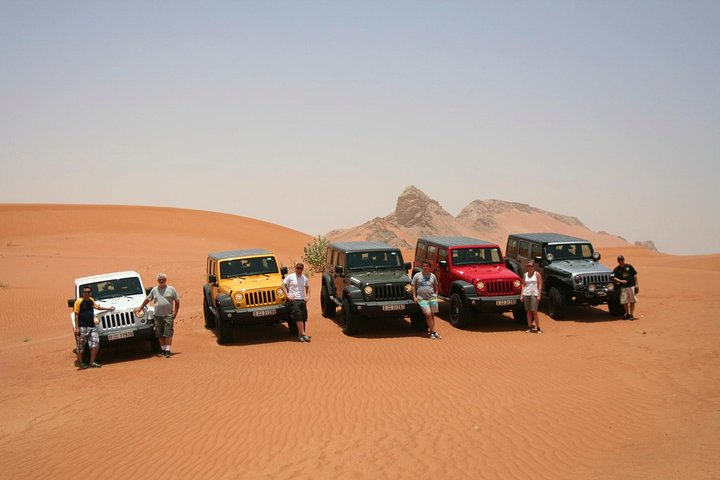 Experience the joy of driving a Jeep Wrangler across vast golden sands engaging with the desert's rugged terrain and creating unforgettable family memories under the UAE sun.